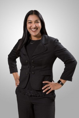 A woman in black suit posing for the camera.